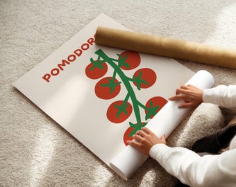 May include: A white poster with the word "POMODORO" in red letters and a green and red tomato illustration. The poster is rolled up with a brown paper tube on a light-colored carpet.