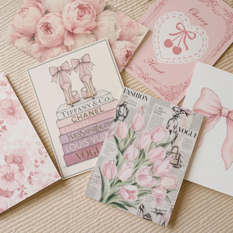 May include: A collection of five rectangular art prints featuring pink and white themes. Designs include a stack of designer books with high heels, a bouquet of pink tulips over newspaper text, a large pink bow, a heart with cherries, and pink peonies.