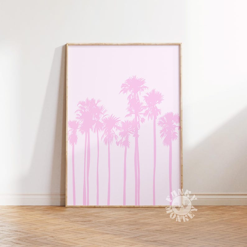 May include: A framed art print featuring a row of pink palm trees against a soft pink background. The artwork is displayed in a light-colored wooden frame, creating a minimalist and modern aesthetic. The print is a decorative piece.