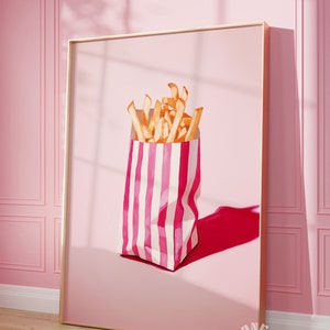 May include: A pink and white striped paper bag filled with golden french fries. The bag is sitting on a pink background with a shadow.