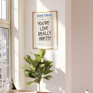 May include: A framed print with a vintage guest check design. The text on the print reads "You're like really pretty".