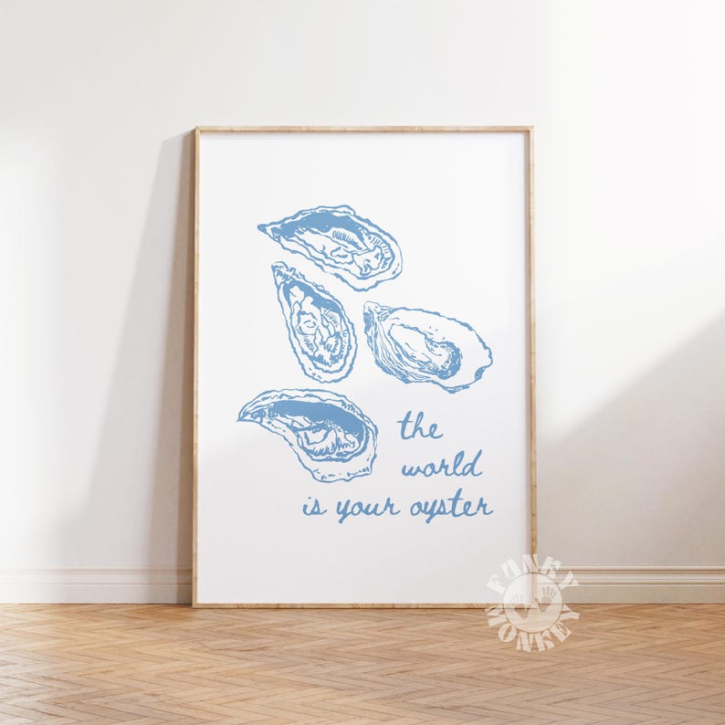 May include: A framed print featuring four blue oyster illustrations on a white background. The phrase "the world is your oyster" is written in blue script below the oysters. The artwork is displayed on a wooden floor.