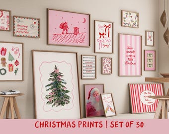 May include: A selection of framed Christmas prints, showcasing festive imagery and text. The prints depict Santa Claus, Christmas trees, and seasonal greetings. The colour scheme is predominantly pink, red, and green, creating a cheerful holiday atmosphere.