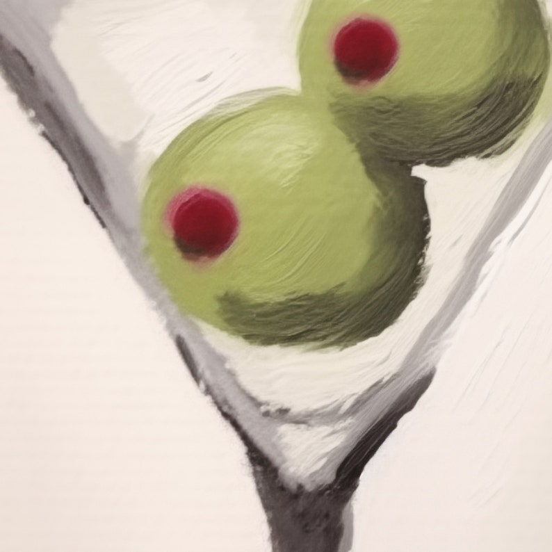 Peut inclure: Deux olives vertes avec des centres rouges dans un verre &agrave; martini. Les olives sont partiellement immerg&eacute;es dans le verre, qui est rempli d'un liquide clair.