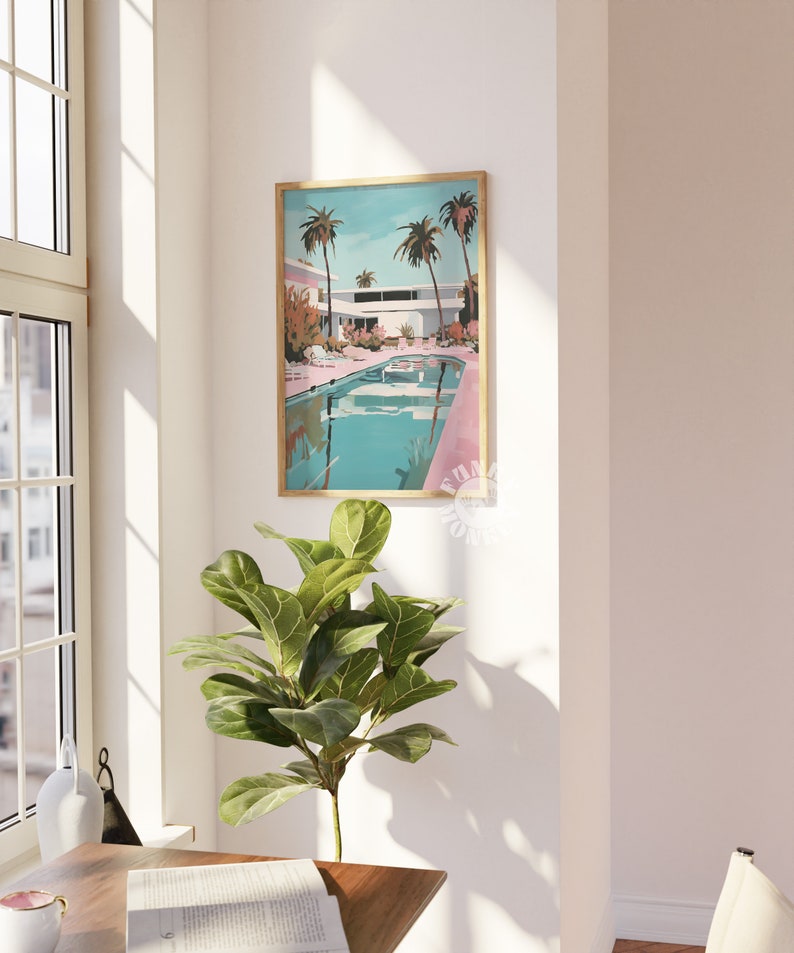 May include: A framed print of a mid-century modern house with a swimming pool and palm trees. The house is painted in shades of pink and white, and the pool is a vibrant turquoise blue.
