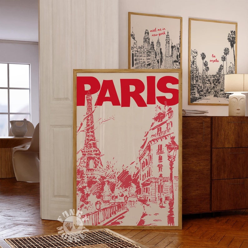 May include: A vintage-style poster with the word "PARIS" in large red letters. The poster features a black and white illustration of the Eiffel Tower and other Parisian buildings in a red hue.