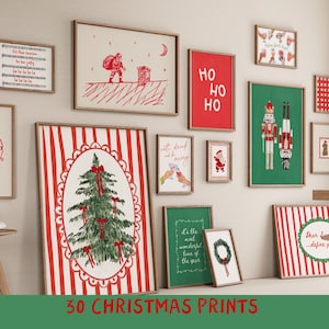 May include: A collection of framed Christmas prints in various sizes and designs. The prints feature festive imagery such as a Christmas tree, Santa Claus, nutcrackers, and holiday phrases. The color palette includes red, green, and white.