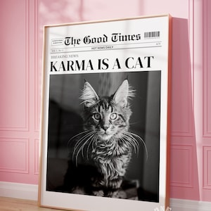 May include: A black and white newspaper headline reads "The Good Times" with the subheading "HOT NEWS DAILY" and the breaking news story "KARMA IS A CAT". A black and white photo of a cat with green eyes is featured below the headline.
