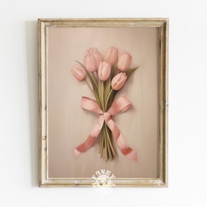 May include: A framed print of a bouquet of pink tulips tied with a pink ribbon. The background is a light brown color.