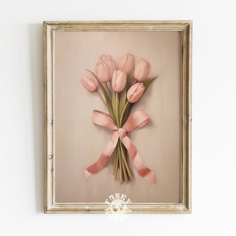 May include: A framed print of a bouquet of pink tulips tied with a pink ribbon. The background is a light brown color.