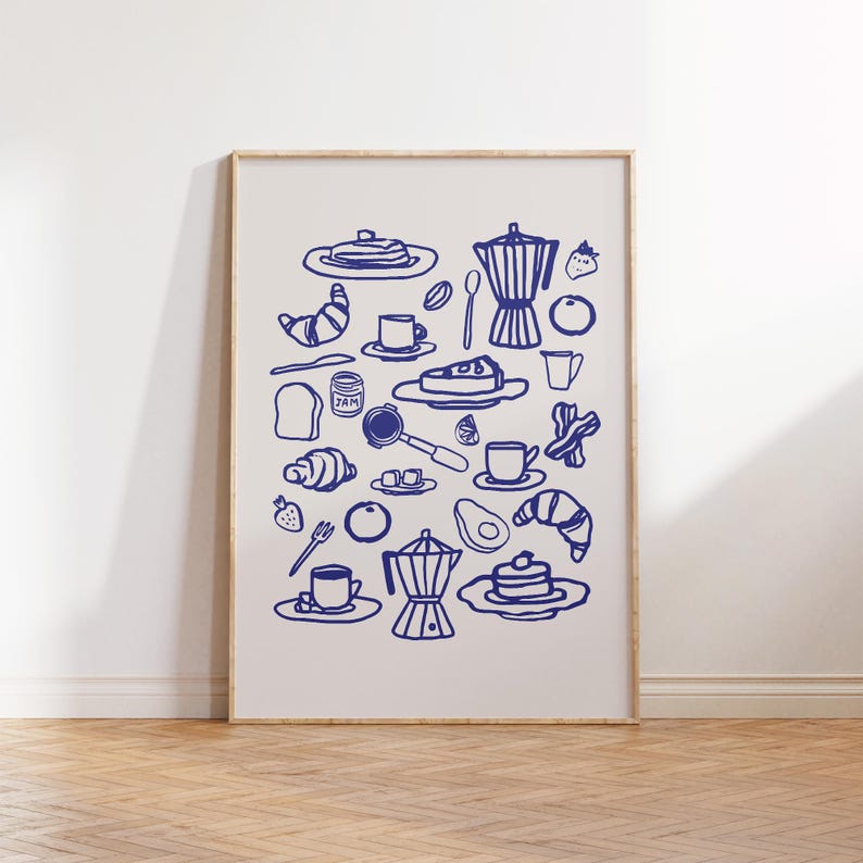 May include: A framed print featuring a collection of blue line art illustrations of breakfast items. The artwork includes coffee pots, croissants, pancakes, fruit, and coffee cups, creating a charming and thematic display.