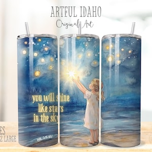 May include: A stainless steel tumbler with a watercolor design of a girl reaching for a star in a night sky. The tumbler has the text "you will shine like stars in the sky" and "Phil 2:15 NIV".