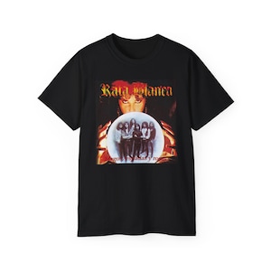 May include: Black t-shirt with a graphic of the band Rata Blanca. The design includes the band's name in gold, a group photo, and the album title. The shirt has a vintage rock and roll aesthetic.
