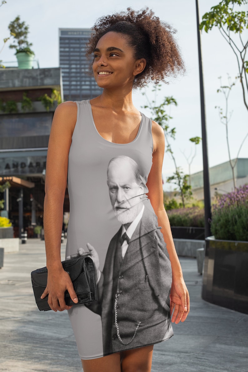 May include: A gray tank dress with a black and white image of Sigmund Freud printed on the front. The image shows Freud in a suit and tie, holding a cigar in his right hand.