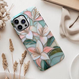 Stargazer lily stained glass phone case with blush pink flowers, green leaves, and teal faux glass background, printed flat with a 3D look.