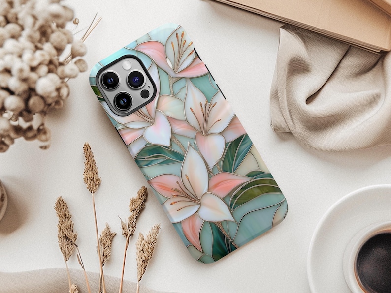 Stargazer lily stained glass phone case with blush pink flowers, green leaves, and teal faux glass background, printed flat with a 3D look.