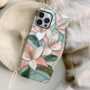 Stargazer lily stained glass phone case with blush pink flowers, green leaves, and teal faux glass background, printed flat with a 3D look.