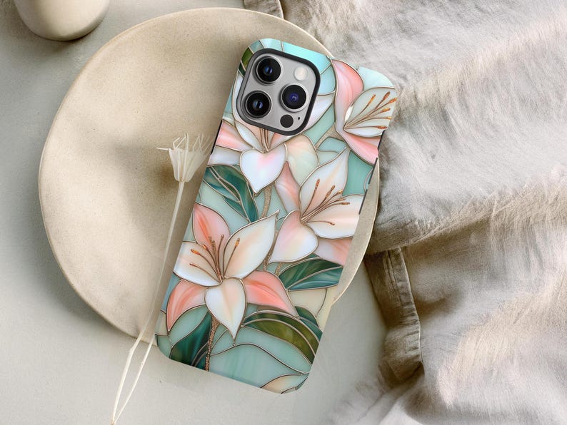 Stargazer lily stained glass phone case with blush pink flowers, green leaves, and teal faux glass background, printed flat with a 3D look.
