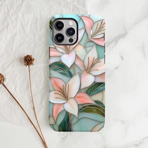 Stargazer lily stained glass phone case with blush pink flowers, green leaves, and teal faux glass background, printed flat with a 3D look.