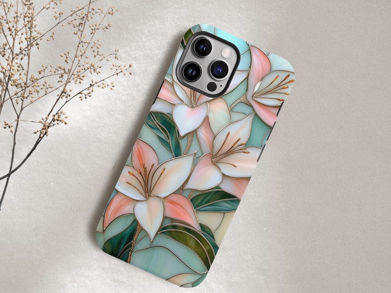 Stargazer lily stained glass phone case with blush pink flowers, green leaves, and teal faux glass background, printed flat with a 3D look.