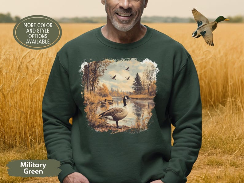 Retro fall scene with a goose by the lake and geese flying overhead, printed on a cozy 90s-style nature crewneck sweatshirt or unisex t-shirt, perfect for bird lovers and wildlife gift giving