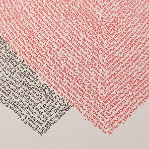 detail of twee gearts written wirh names, one heart in black and one in red.