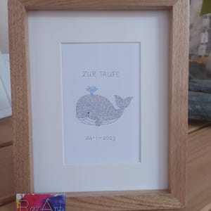 Front view of an image of a baby whale. The complete image consists entirely of handwritten words. In this image the words are hundreds of times the name of the newborn baby.
Under the baby whale is written the date of the baptism.