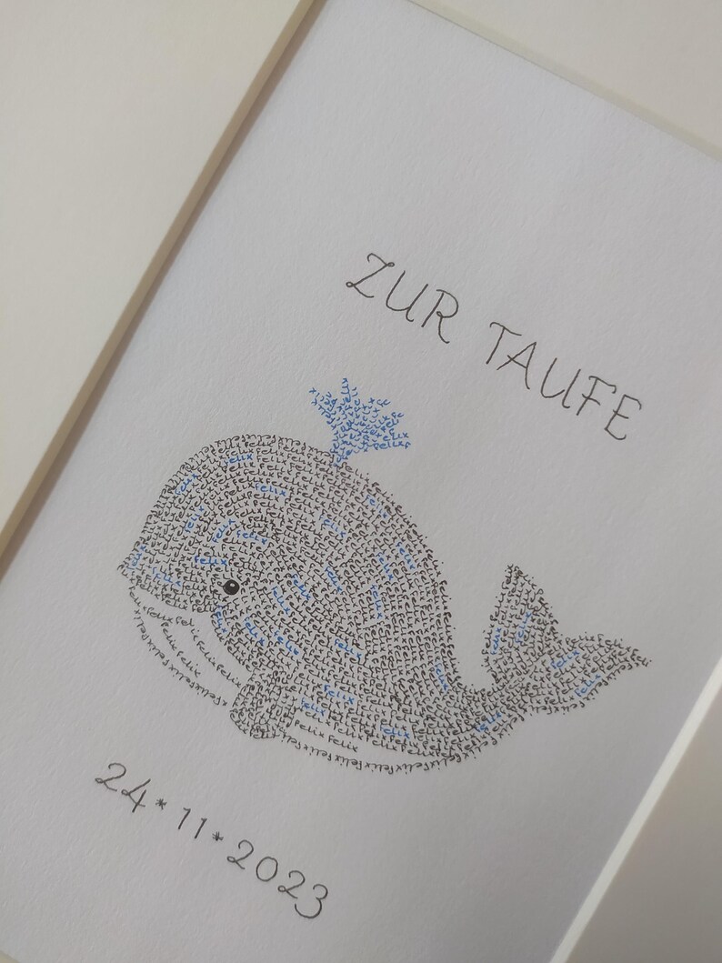 Close up photo of an image of a baby whale. The complete image consists entirely of handwritten words. In this image the words are hundreds of times the name of the newborn baby.
Under the baby whale is written the date of the baptism.