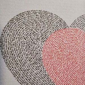 May include: A heart-shaped illustration composed of repeated handwritten text. The left side features the name Daniel written in black ink, while the right side features the name Nadine written in red ink, both following the heart's curved outline.
