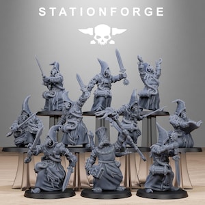 May include: A collection of gray miniature figures, each depicting a robed character with a pointed hood, holding weapons or books. The figures are arranged on tiered platforms. The text "STATIONFORGE" and a skull logo are at the top.