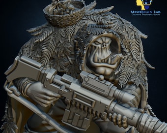 May include: A 3D printed miniature of an Orc warrior wearing a camouflage cloak with a bird's nest on top. The Orc is holding a large rifle and has a fierce expression on its face.