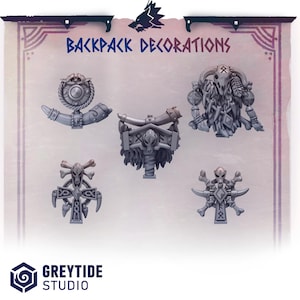 May include: A collection of gray backpack decorations with a Viking theme. The decorations include horns, skulls, and crossbones. The text "BACKPACK DECORATIONS" is displayed at the top of the image.