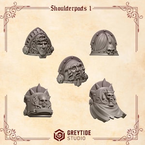May include: Five 3D printed shoulder pads for miniature figures. Each pad features a different design with a skull, face, or multiple faces. The shoulder pads are gray and have a textured surface.