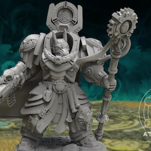 May include: A gray, detailed miniature figure of a space marine with a staff and a gun. The figure is wearing a helmet with a skull and a cape. The figure is standing on a base. The background is a blurry green and blue.