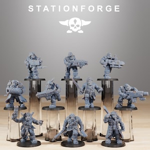 May include: A set of ten gray plastic miniature figures of orcs, each with a different pose and weapon. The figures are standing on small clear plastic bases. The figures are arranged in a row on a gray surface. The figures are all painted in a gray color. The figures are all about 2 inches tall. The figures are all part of a fantasy game.