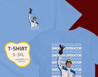 May include: Light blue t-shirt featuring a graphic of a person raising their hand, with the text "SAINZ" below. The back of the shirt has the words "SMOOTH OPERATOR" repeated. The shirt is available in sizes S-3XL and in 3 colors.