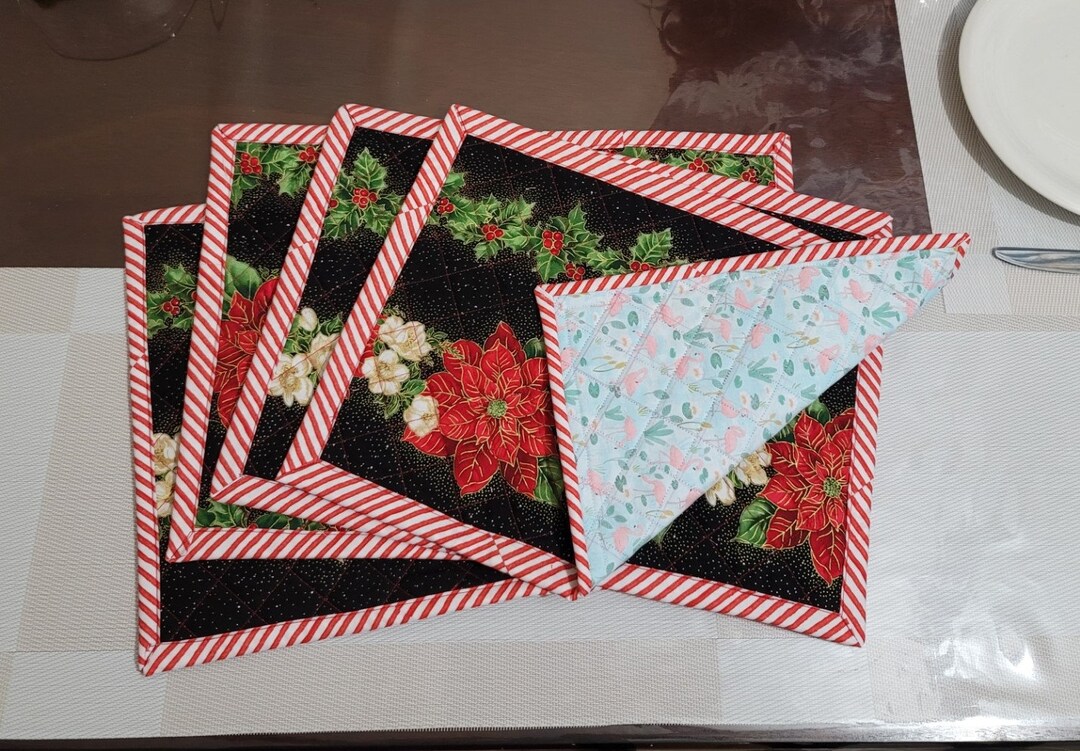 A Set of 4 Christmas Quilted Placemats in Poinsettia front and Flamingo