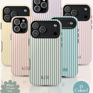 May include: Several iPhone cases in pastel shades, each with a vertical striped design. The cases showcase the phone's camera array and have initials. The image includes text stating "iPhone 17 Cases Now Available!" and "15 Colors!"