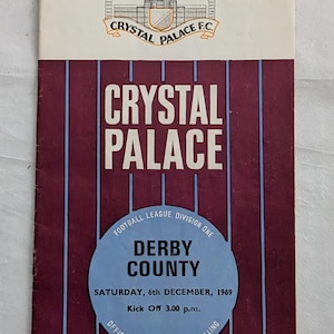 May include: Vintage Crystal Palace F.C. football program. The cover features the team's crest and the words "Crystal Palace" in large white letters. The program announces a match between Crystal Palace and Derby County on December 6, 1969.