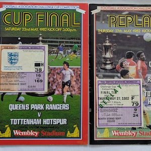 May include: Two vintage souvenir programs from the Football Association Challenge Cup Competition. The first, red-bordered, announces the Cup Final on May 22, 1982, between Queens Park Rangers and Tottenham Hotspur. The second, black-bordered, announces the Replay on May 27, 1982.