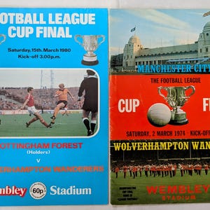 May include: Two vintage Football League Cup Final programs. The blue program features the 1980 match between Nottingham Forest and Wolverhampton Wanderers. The red program highlights the 1974 match between Manchester City and Wolverhampton Wanderers.