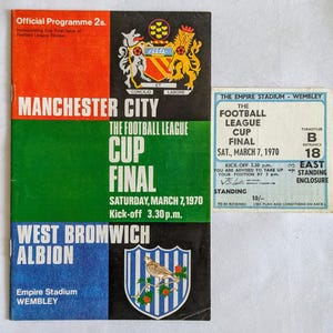 May include: A green and white program for the 1970 Football League Cup Final between Manchester City and West Bromwich Albion. The program features the team crests and the date and time of the match. The Empire Stadium - Wembley ticket is also visible.