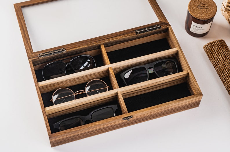 Handcrafted wooden sunglasses case for 6 glasses with a stylish design and glass lid so you can always see your glasses, even when box is closed. Each compartment has a felt lining to protect your glasses from scratching.