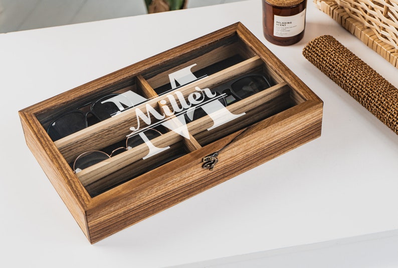 Handcrafted wooden sunglasses case for 6 glasses with a stylish design and big custom engraving in the center of the glass lid. Each compartment has a felt lining to protect your glasses from scratching.