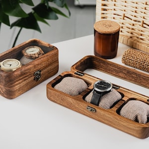 Unique Wood watch box for watches, featuring rounded corners, a sleek, treated wood texture, and a glass lid for constant visibility. Customize the glass lid with your own engraving.