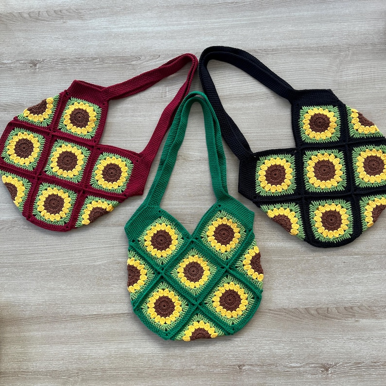 May include: Three crocheted tote bags with sunflower designs. The bags are in red, green, and black.