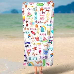 May include: A white beach towel with a colorful pattern of beach-themed illustrations and the name "Elijah" repeated throughout. The illustrations include ice cream cones, watermelon slices, seashells, sunglasses, beach balls, starfish, buckets, and a red and yellow toy truck.