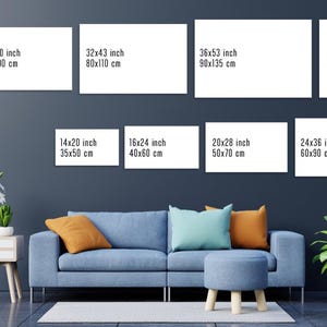 May include: A contemporary living room setting featuring a blue sofa, cushions in orange and teal, and a small footstool. Above the sofa, there are several rectangular white canvases with size dimensions in inches and cm, including a 28x40 inch (70x100 cm) canvas.