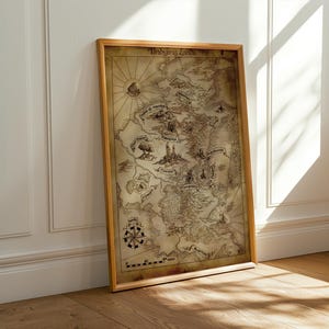 May include: A framed map with a vintage aesthetic, featuring a detailed illustration of a fantasy world. The map is in a wooden frame and leans against a white wall. The map includes a compass rose and the text "Unsung Lands".