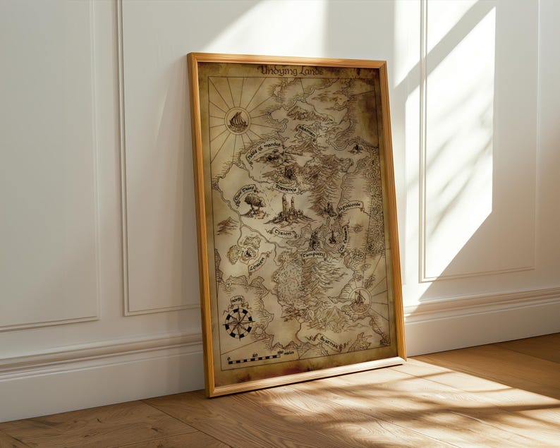 May include: A framed map with a vintage aesthetic, featuring a detailed illustration of a fantasy world. The map is in a wooden frame and leans against a white wall. The map includes a compass rose and the text "Unsung Lands".